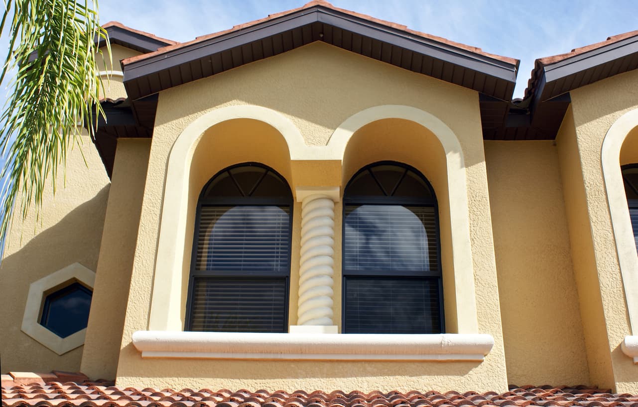 Arched impact windows on stucco Florida home